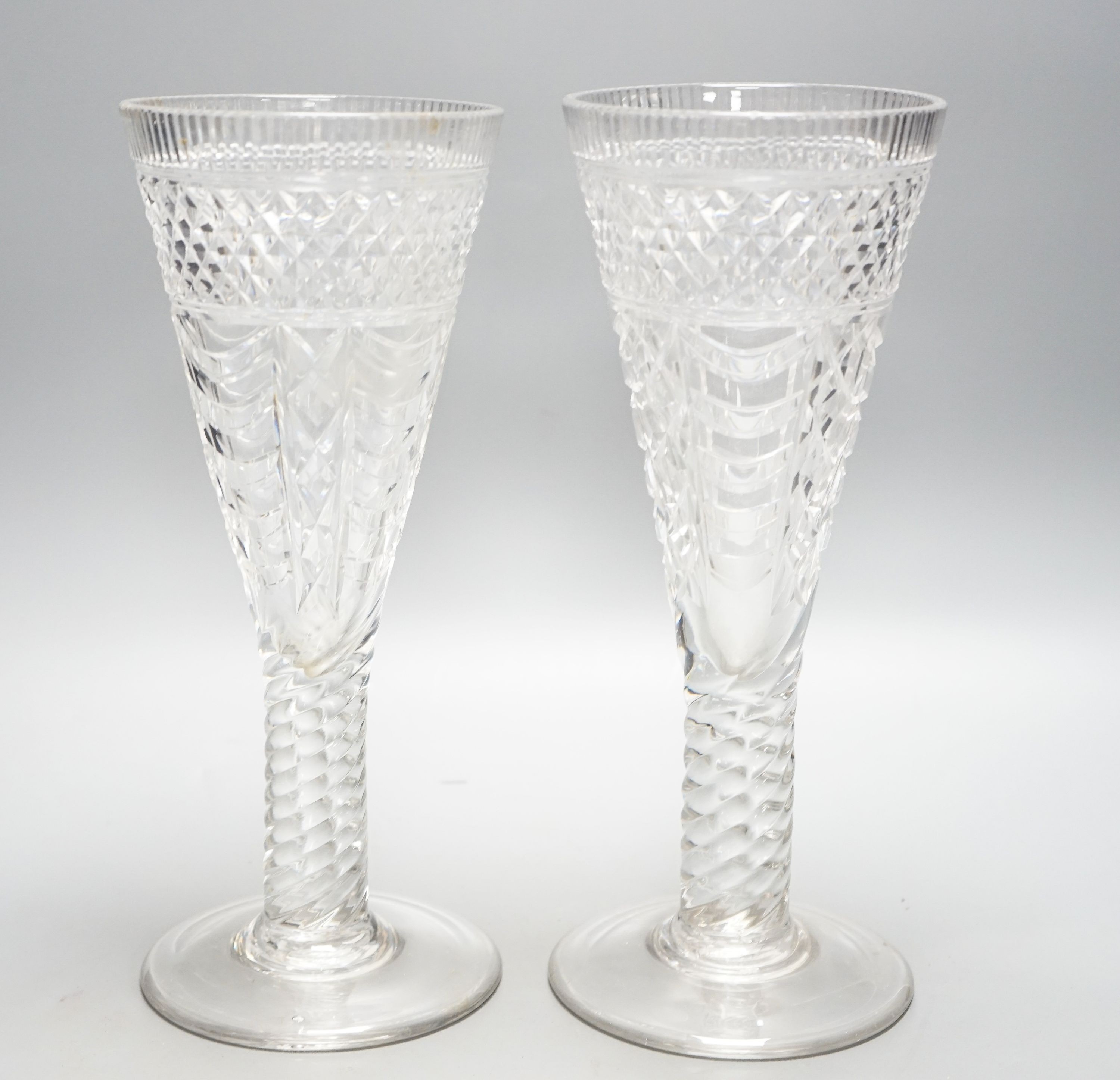 A pair of 19th century large glass goblets or vases, each on spiral-twist stem and circular foot with pontil mark 30cm